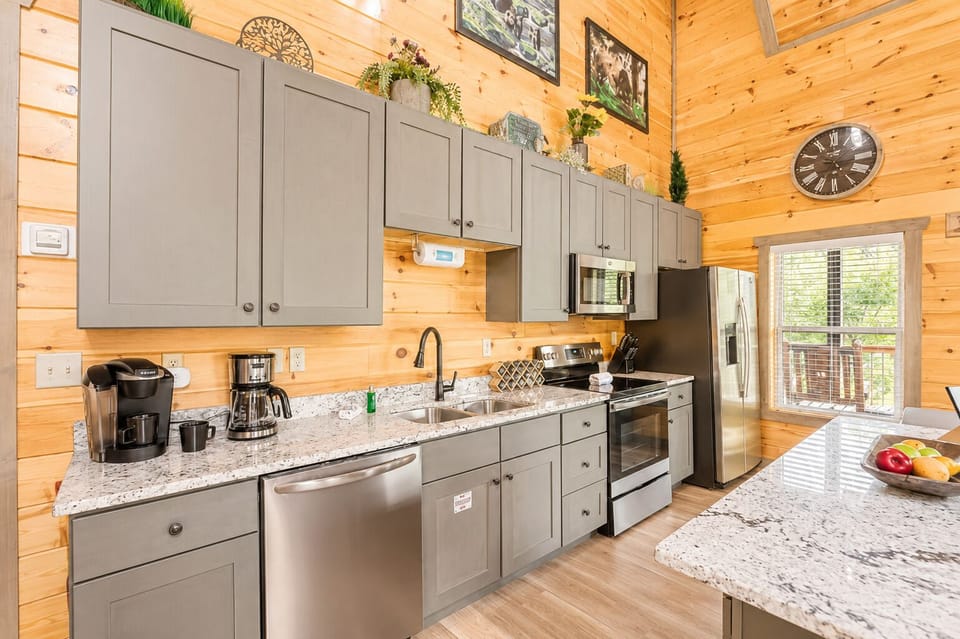 Spacious cabin kitchen with granite counters, island, and stainless appliances