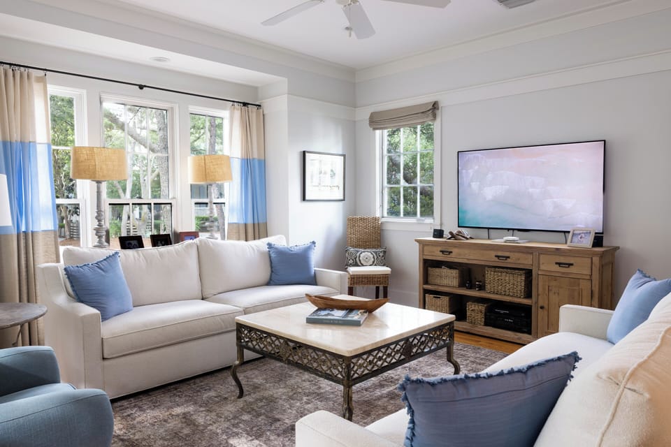 Unwind in your bright, airy living space with plush seating, calming coastal tones, and entertainment ready to go. Large windows frame garden views while you relax in comfort.