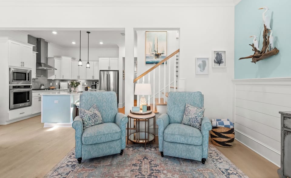 This bright open living space is where you'll find a chef's kitchen, cozy nautical touches, and room to gather with loved ones right at home.