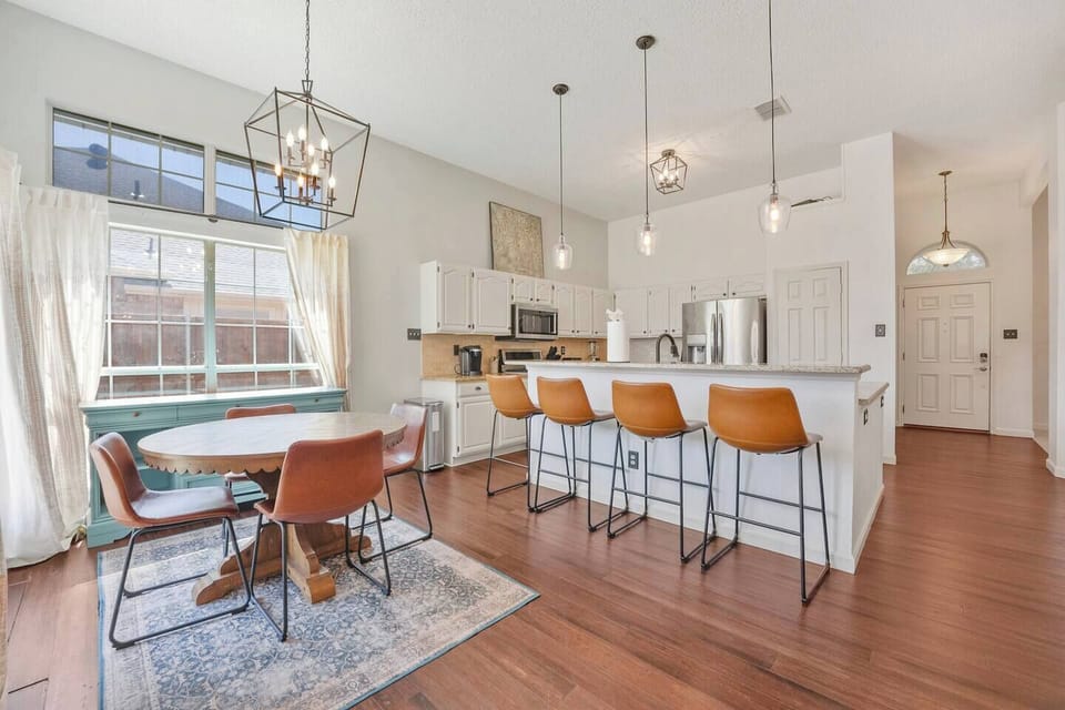 Bright and inviting kitchen with modern appliances, a spacious breakfast bar, and a cozy dining area. Perfect for cooking, dining, and gathering with friends and family.