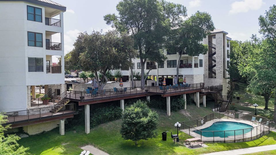 Inverness Condos provides a gorgeous outdoor community space with a patio, pool, Comal River access and more!
