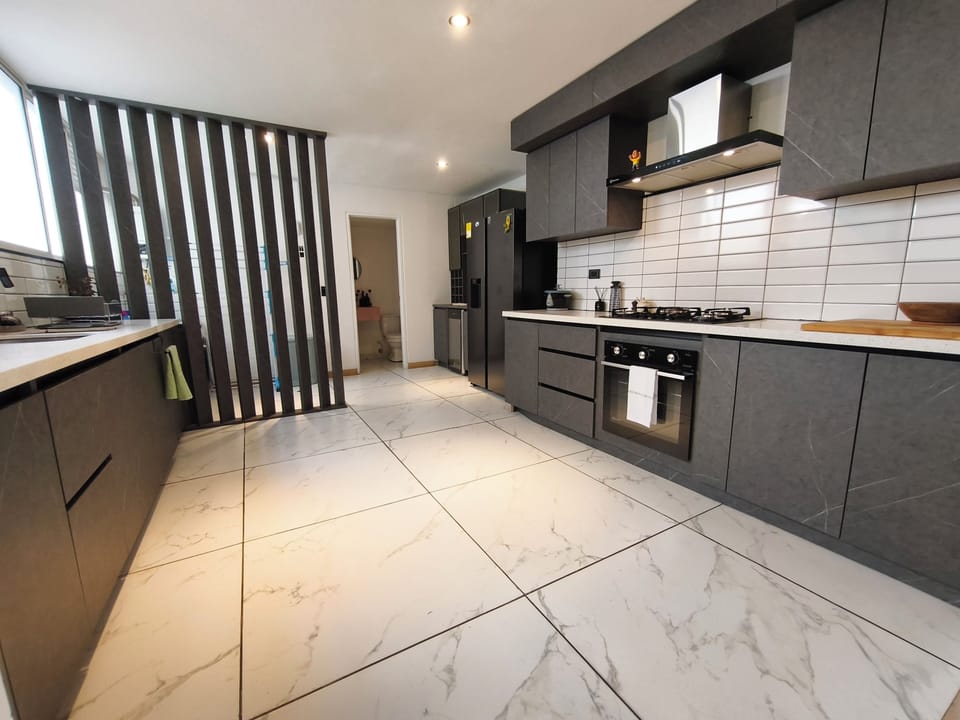 Open kitchen, coffee maker, stovetop, fridge, microwave, standard oven, half-bathroom