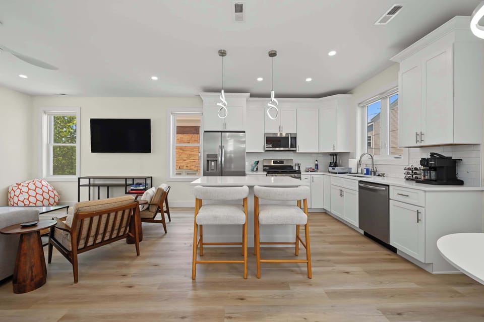 Open floor plan connecting the living room, dining area, and kitchen