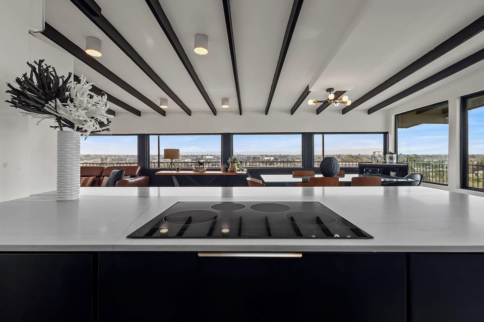 Open-concept kitchen with panoramic windows and sweeping city views.