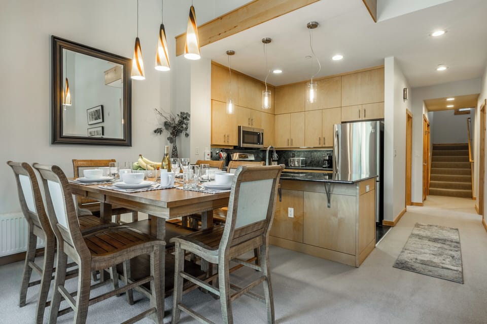 Gather around this inviting dining table where your group can share meals and memories. The open kitchen layout and modern appliances make cooking together a breeze.