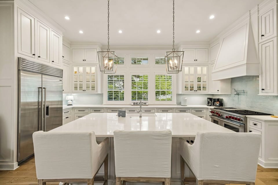 Step into this bright, elegant kitchen where your culinary dreams come alive. Gleaming countertops, top-tier appliances, and abundant natural light create a welcoming space for memorable meals.