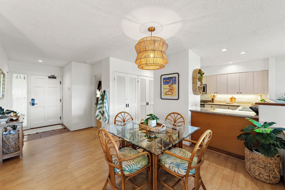Step into your coastal retreat where island charm meets home comfort. Natural wood and tropical touches create an inviting space perfect for gathering around morning coffee or planning your day's adventures.