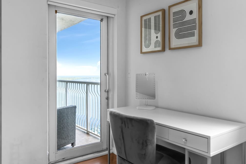 The primary queen suite boasts a private ensuite, desk workspace, & balcony access​