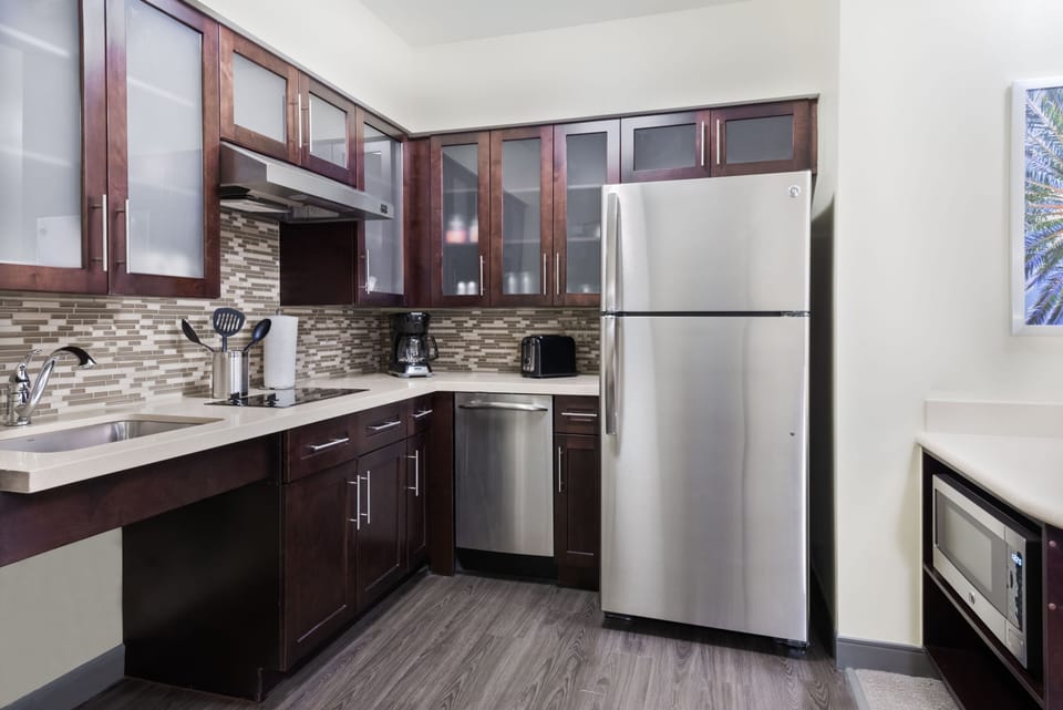 Cook with ease in this modern kitchen, featuring sleek cabinets and stainless steel appliances.