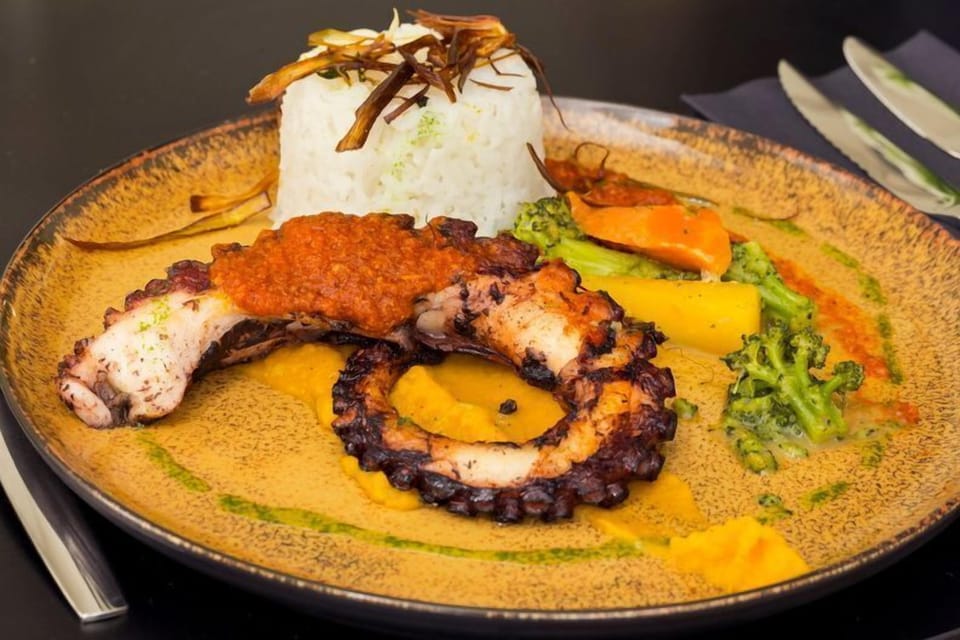 Grilled octopus with vibrant vegetables - a signature dish at La Table Consulaire, celebrating the bold flavours of Mediterranean gastronomy.