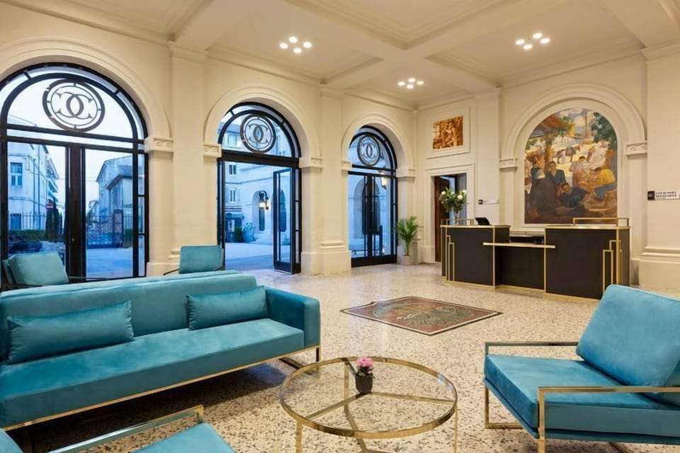 The welcoming hotel lobby, where turquoise furnishings, ornate arches, and decorative mosaic floors set the tone for a prestigious stay.