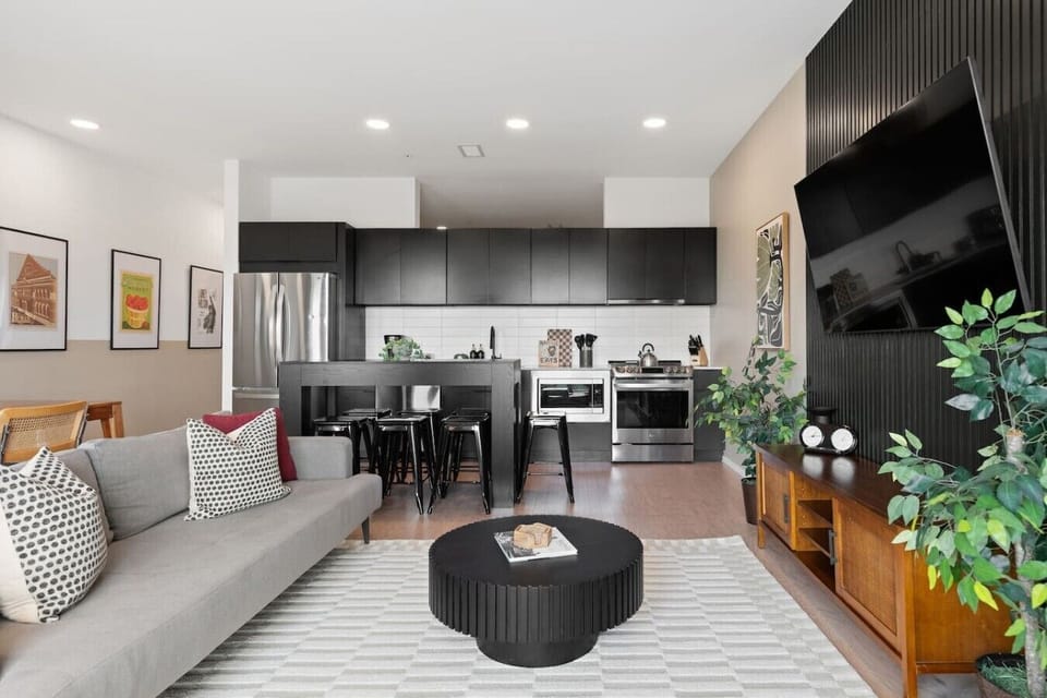 Open concept from the kitchen and dining area into the bright and spacious living with comfortable seating and lots of natural light. Smart TV with all the streaming apps you could want. The couch turns into a sleeper sofa.