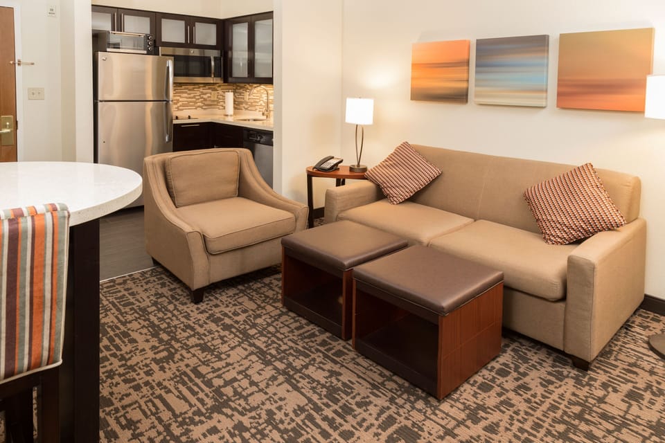 Bright open living space with modern furniture and kitchen.
