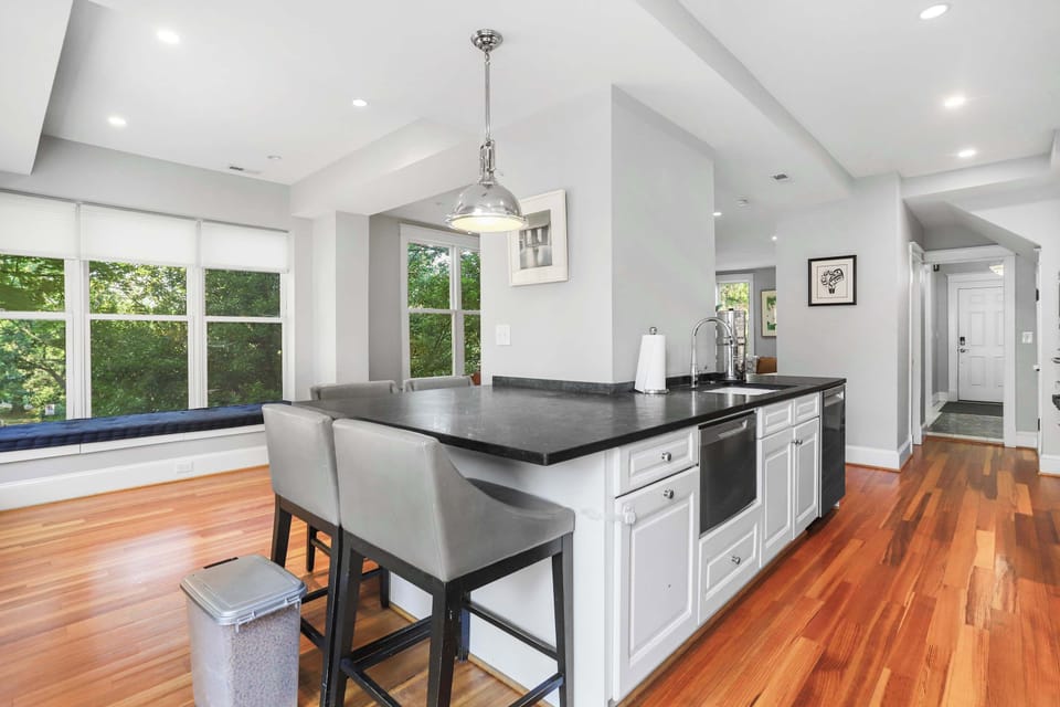 Chef's kitchen with bar seating for 4 and timeless finishes.