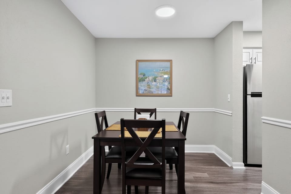 Dining area with seating for four, conveniently located between the kitchen and living room.