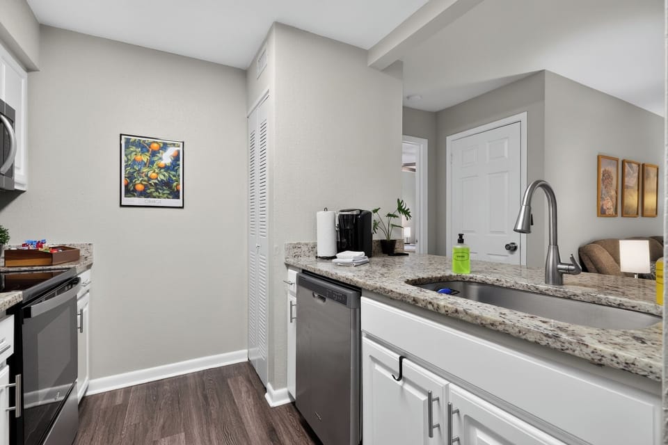 Fully equipped kitchen with glasstop stove, oven, microwave, pantry, coffee station, papertowels, Keurig, doublewide sink, hand soap, dish soap, and dishwasher.