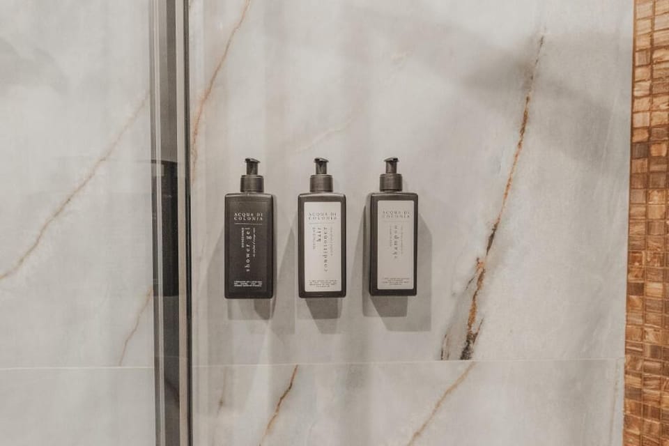 Deluxe Double Room, Balcony, Partial Sea View | Bathroom amenities | Shower, free toiletries, hair dryer, bathrobes