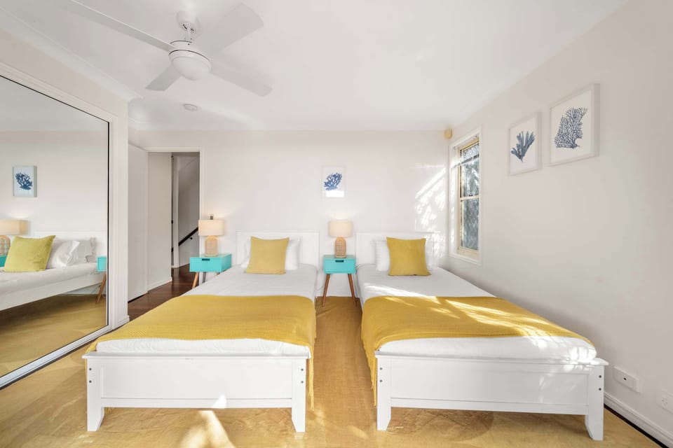 The fourth bedroom includes two single beds, creating a flexible and comfortable space for children or additional guests.
