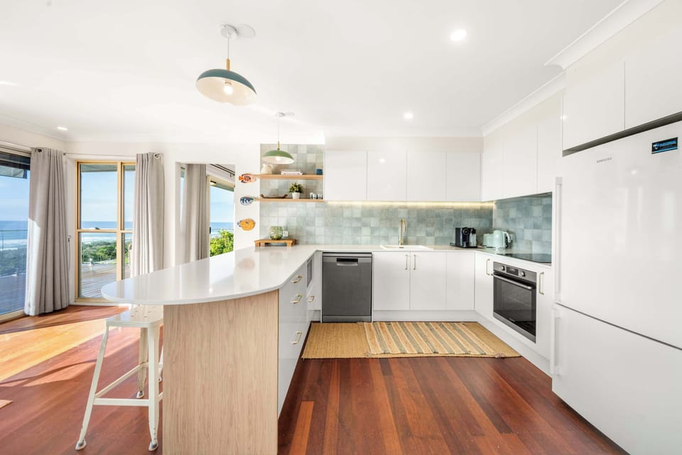 The well-equipped kitchen includes modern appliances and generous bench space, making everything from quick breakfasts to family dinners a breeze.