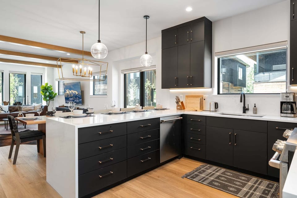 Modern, fully equipped kitchen with an island featuring seating for 4 guests