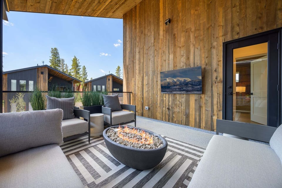 Rooftop loft featuring an outdoor sitting area, gas firepit, and outdoor TV