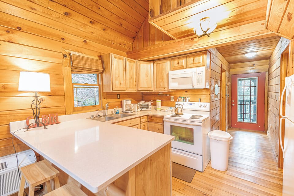 The Kitchen comes complete with a bar area, stove, oven, microwave, electric kettle pot, coffee machine, fridge, freezer and kitchenware. Plenty of space to make meals and congregate. 