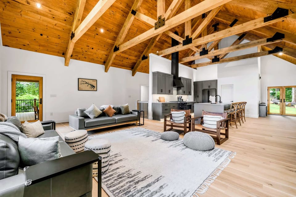Great Room - Full timber-truss ceilings run from the sofas back to the kitchen island.