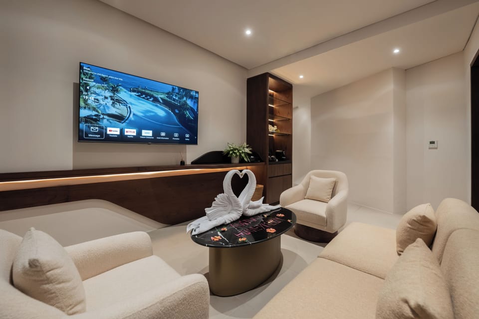 Deluxe Suite | Living area | 48-inch flat-screen TV with digital channels