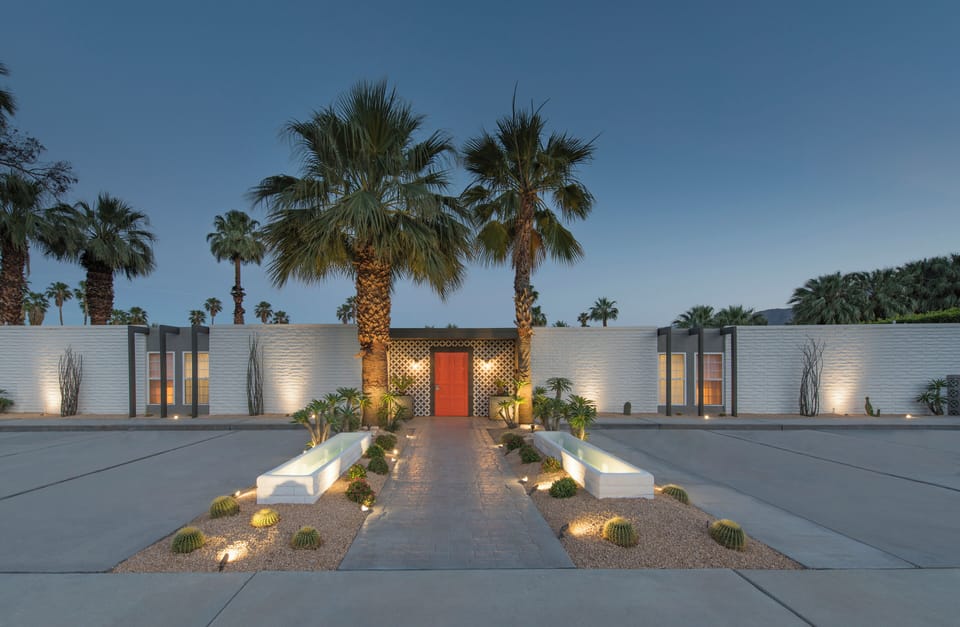 Symmetrical architectural entrance beautifully lit at twilight for an upscale arrival experience.