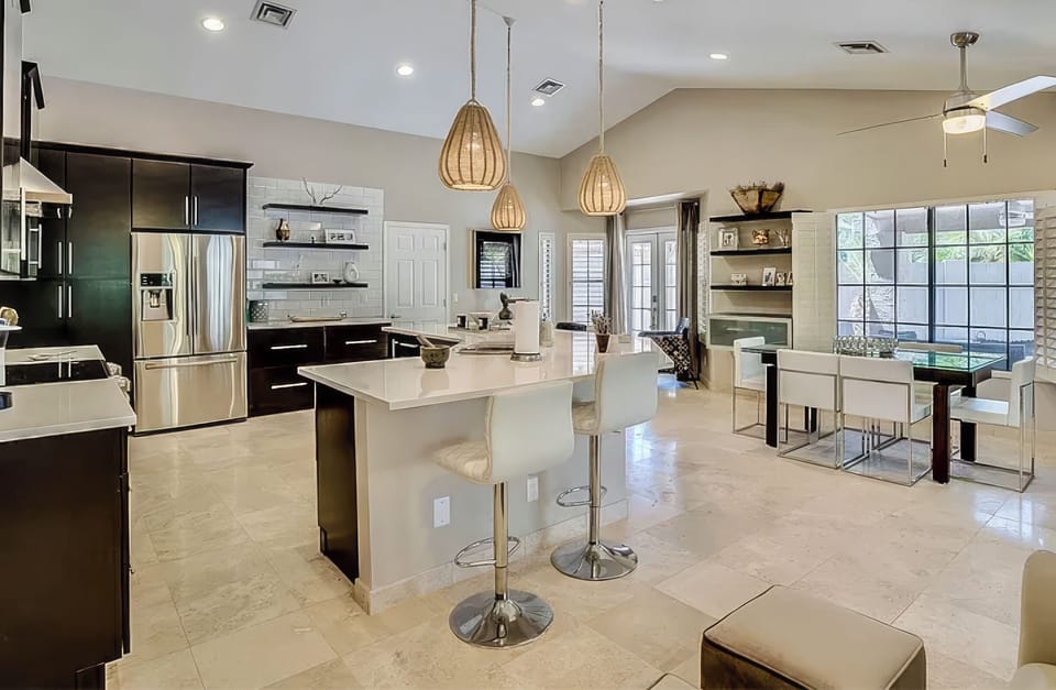 Bright open kitchen with island seating, pendant lighting, and easy flow to the living area.