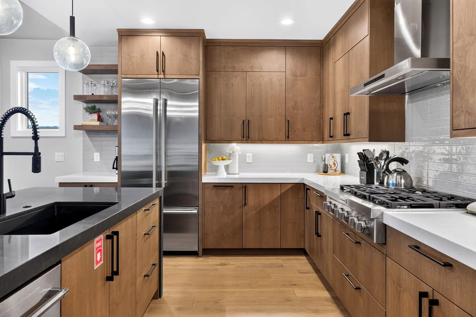 Chef-ready kitchen featuring a spacious refrigerator, ample counter space, a Cuisinart 12-cup drip coffeemaker, and a Philips espresso machine.