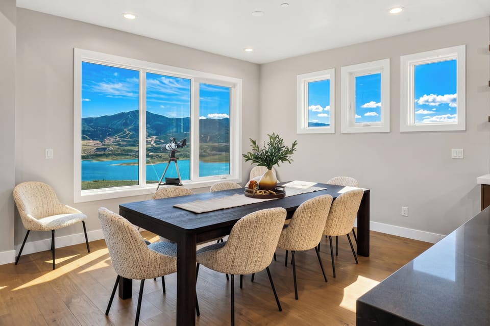 Spacious dining area surrounded by large windows, offering a scenic backdrop for every meal.