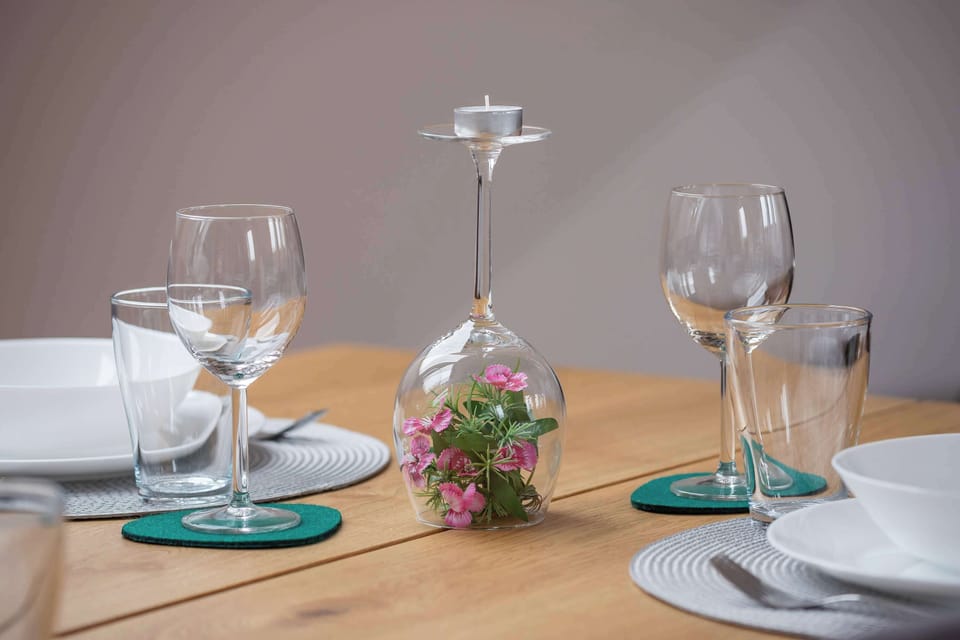 Elegant dining table set for a meal with decorative tableware, creating a welcoming atmosphere.