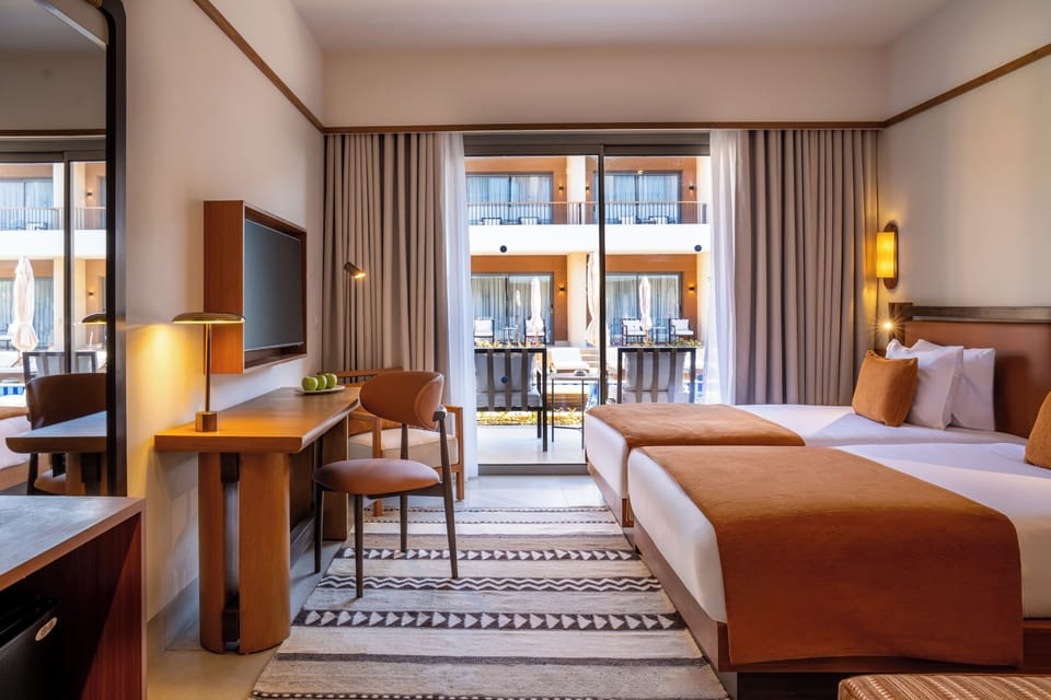 Superior Twin Room, Pool View | Minibar, in-room safe, desk, blackout drapes