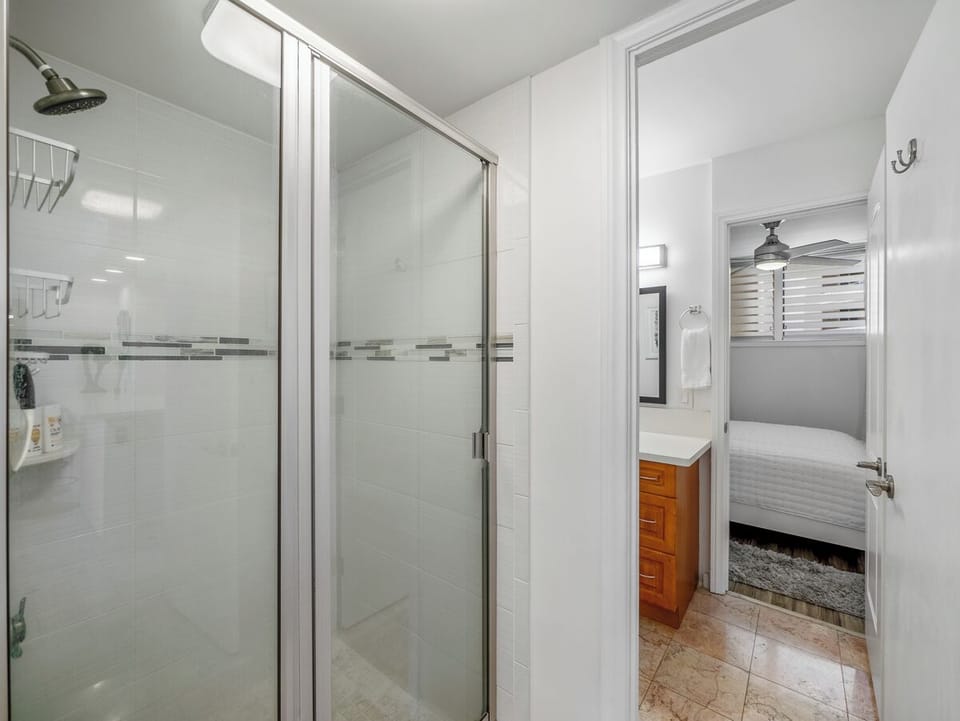 Bathroom - Move easily between the bedroom, private vanity area, and central walk-in shower in this practical Harbor View Plaza layout, designed to support comfortable routines during a 30-night Waikiki stay.