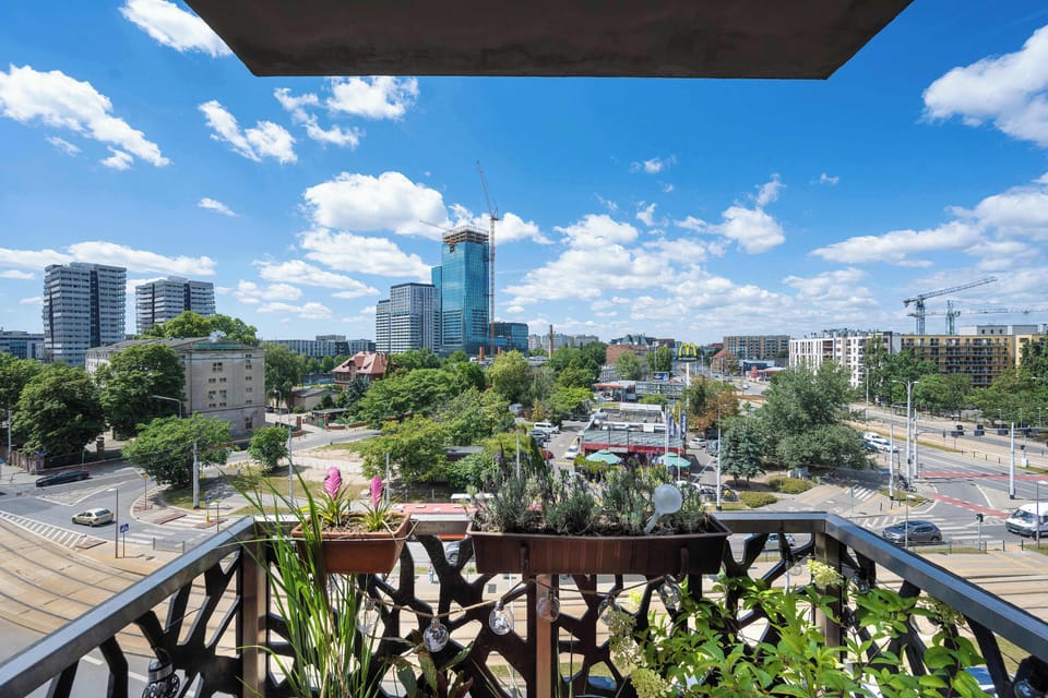 Private balcony offering panoramic views of the city skyline and surrounding residential area.