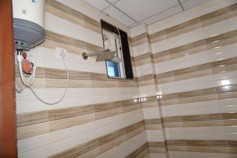 Economy Triple Room | Bathroom | Slippers, towels