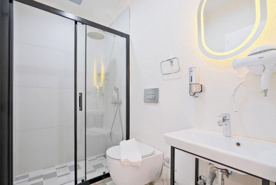 Shower, hair dryer, slippers, towels