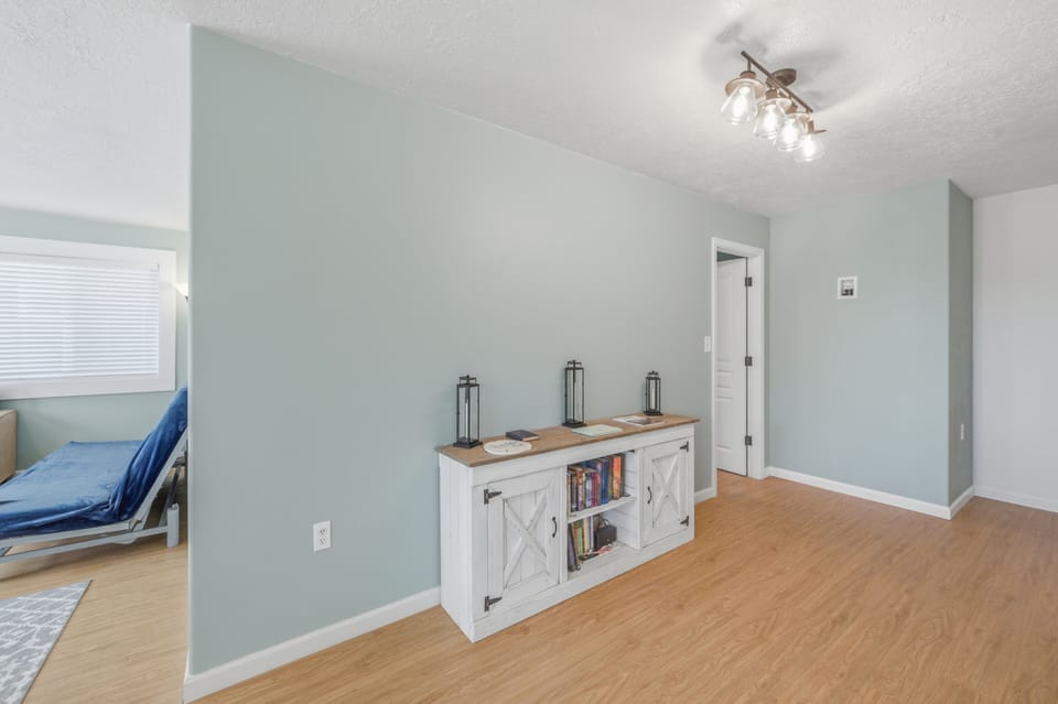 Your upstairs hallway offers a charming barn-door credenza for books and keepsakes, with tasteful lanterns adding warmth as you move between rooms.