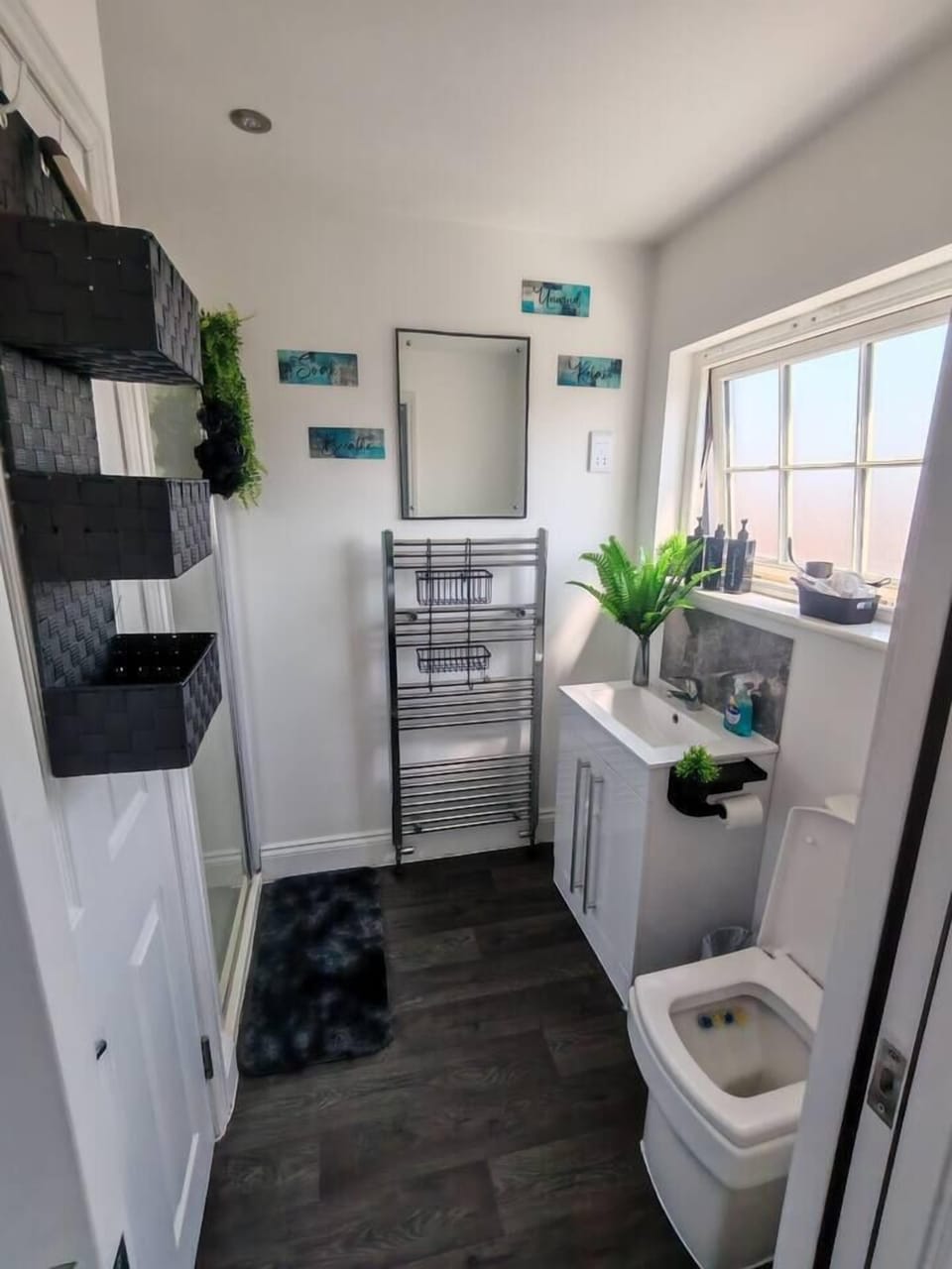 Bright modern bathroom with walk-in shower, natural light, and smart storage