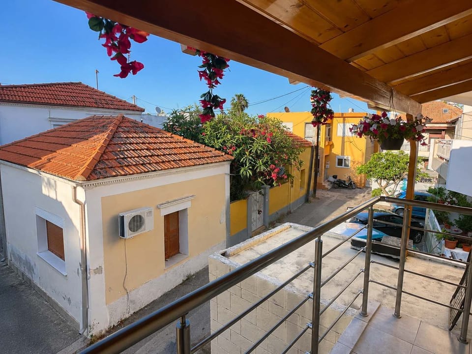 Sunny balcony view overlooking a quiet neighborhood street, a pleasant outdoor spot to enjoy fresh air and a coffee or drink