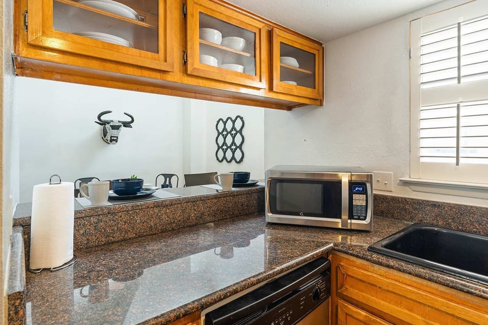Cozy kitchen with granite countertops and modern appliances, perfect for preparing meals during your stay.