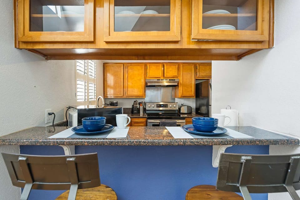 Cozy kitchen with bar seating, perfect for casual dining and entertaining.