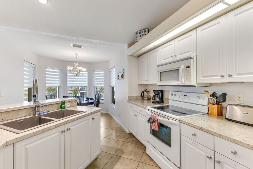 Kitchen | Electric Range & Coffee Station | Open Layout to Dining Area