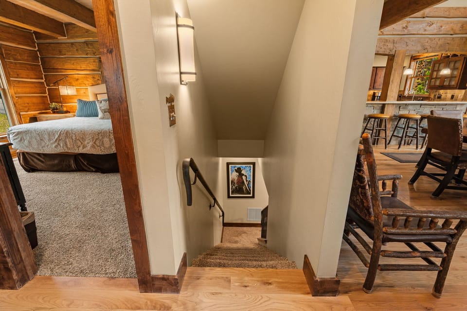 Step into your cozy mountain retreat, where rustic wood beams and warm tones create an inviting atmosphere. The open layout connects your bedroom, dining, and living spaces seamlessly for ultimate comfort.