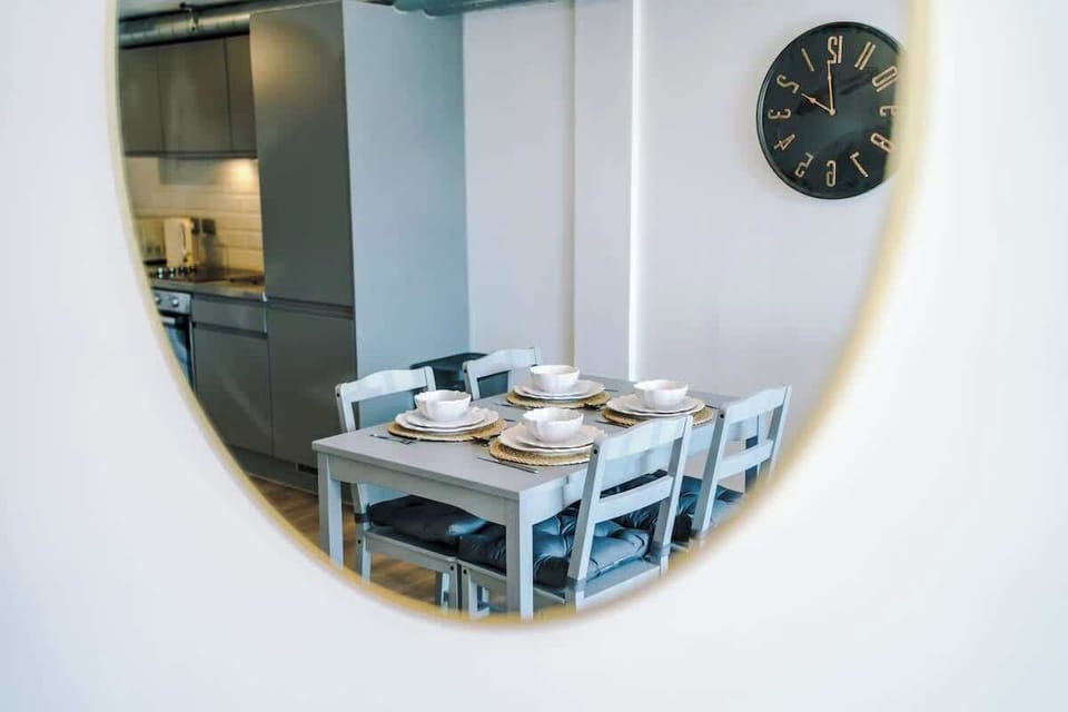 Enjoy meals in the bright dining area, with a stylish table setting and comfortable seating.