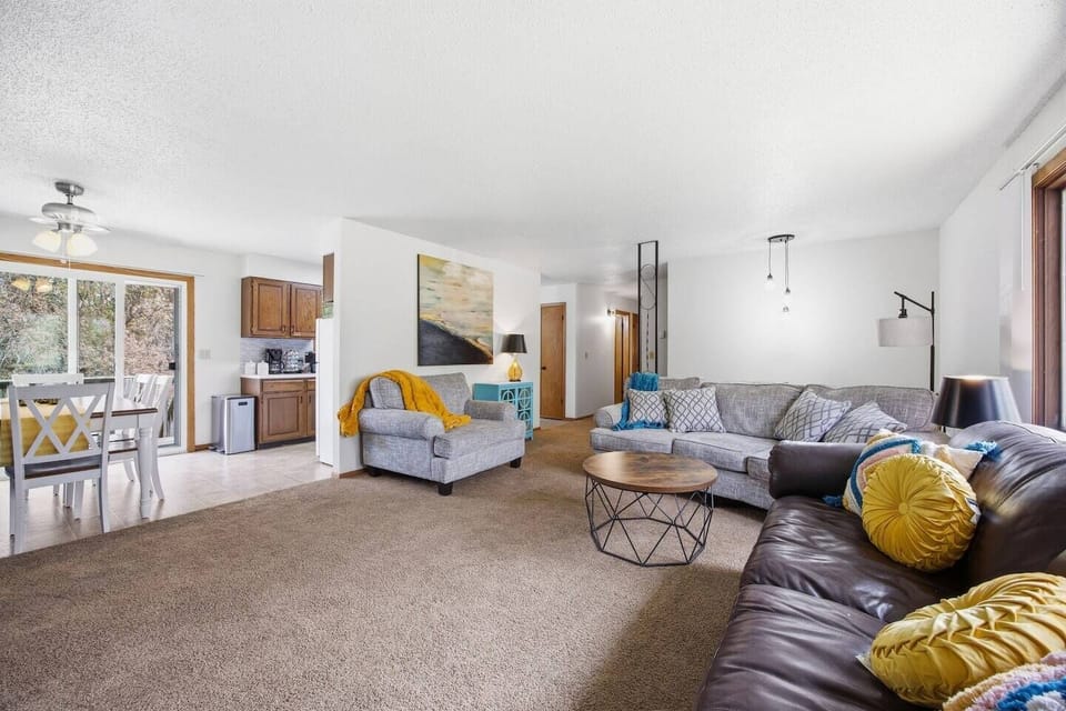 Living room with sufficient seating for a large group. 
