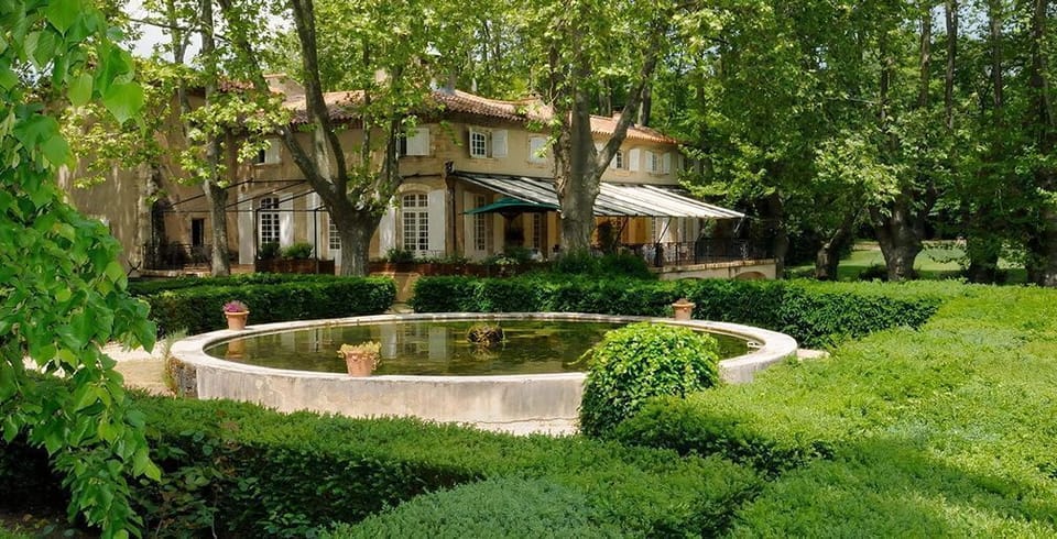 The ornamental garden offers a tranquil retreat within the estate's park, where fountains and lush greenery create a peaceful atmosphere unique to this Provençal setting.