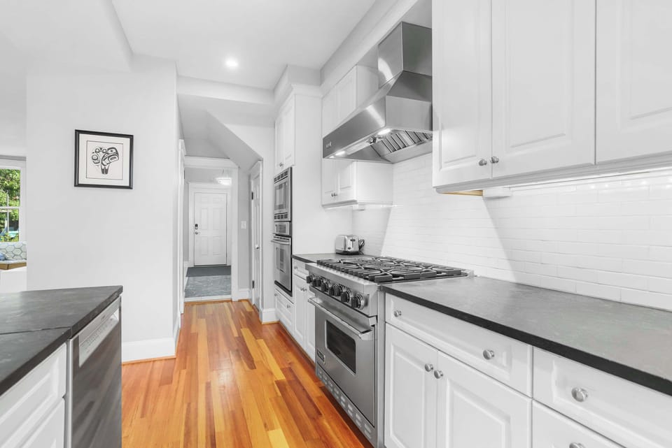 Chef's kitchen with bar seating for 4 and timeless finishes.