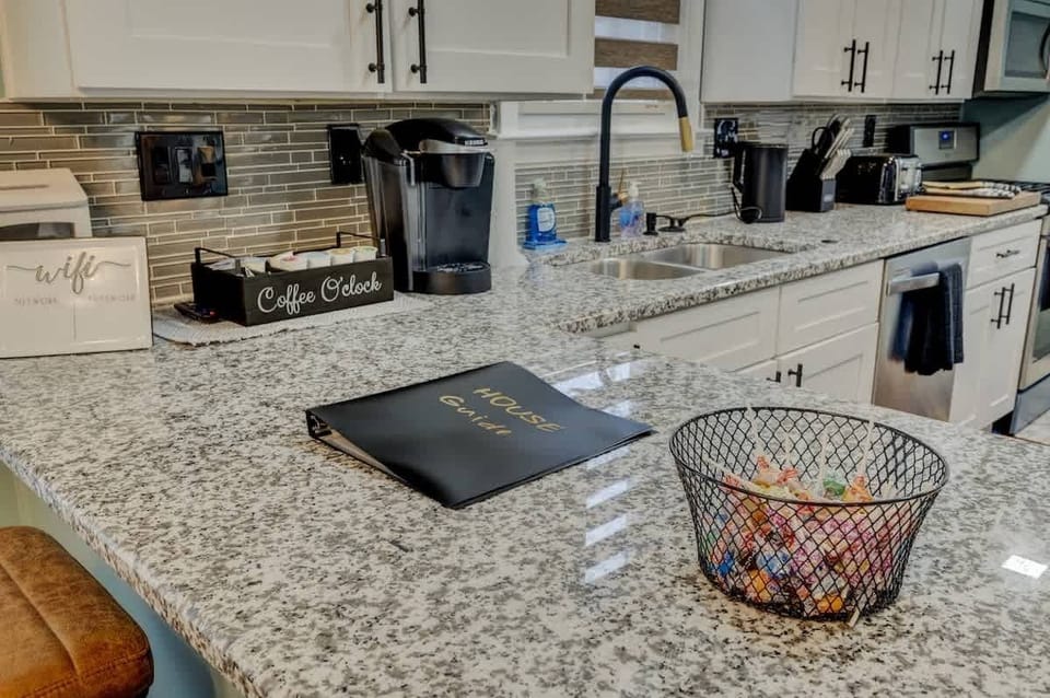 Granite countertop detail w/ sink, prep space & nearby dining setup